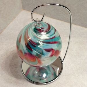 Beautiful blown glass ornament with mirror stand.